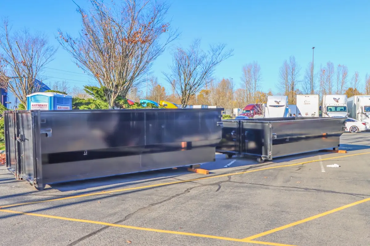 Professional dumpster rental service with roll-off container on residential driveway in Perrysburg